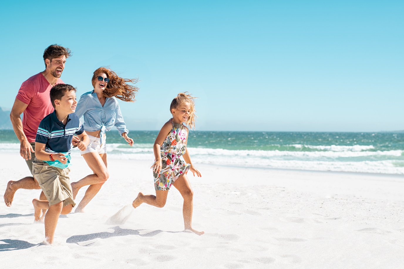 Happy Family Running on Beach